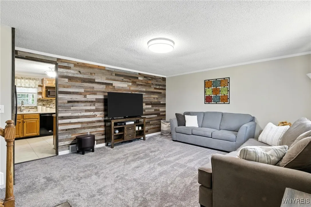 Living room showcases a decorative wood wall, carpet feels so soft under your feet.