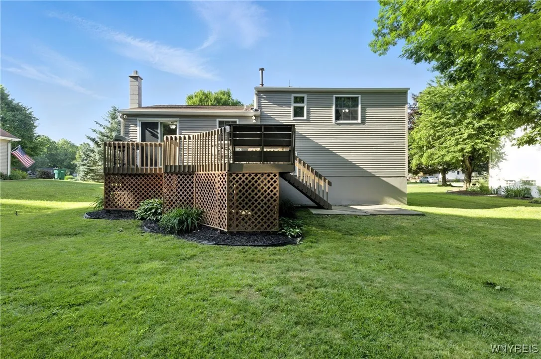 Rear deck has a new set of stairs leading to patio.