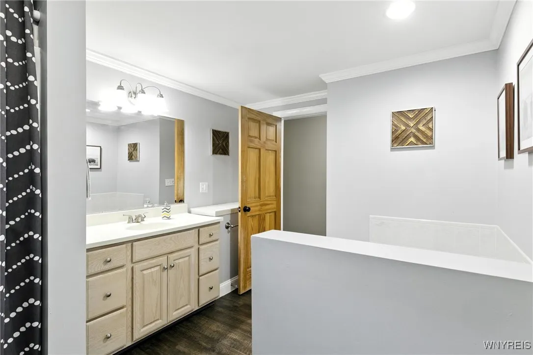Large vanity, additional counter space behind the door and linen closet in hallway.