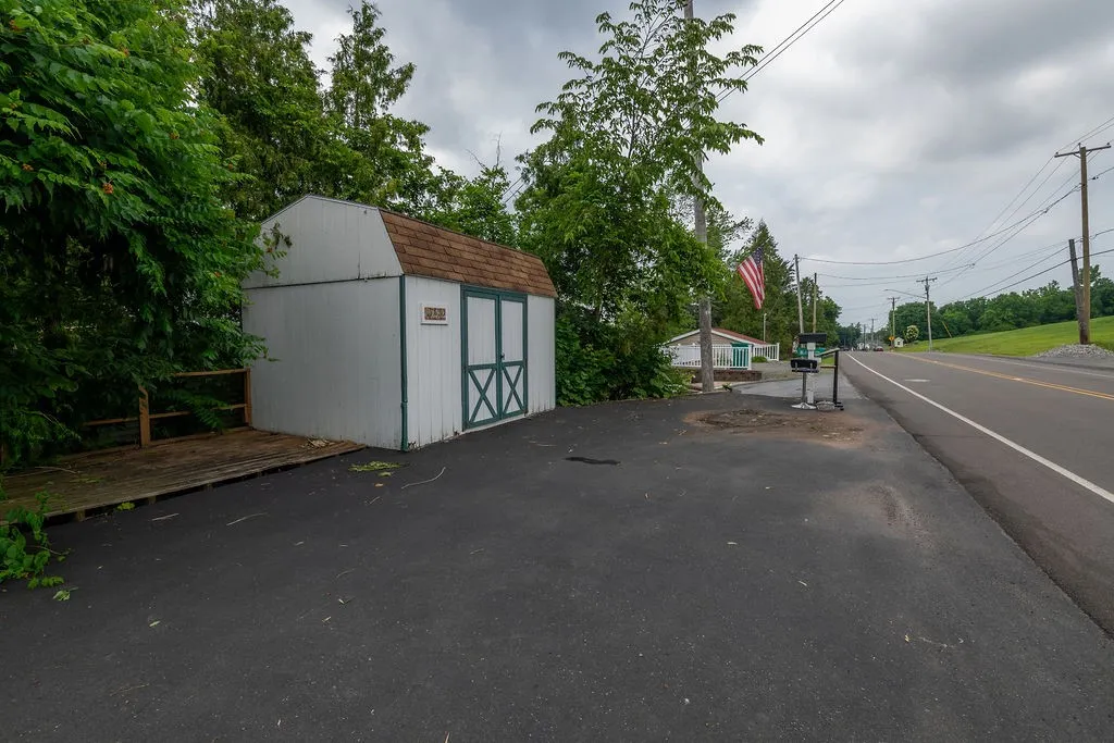 Plenty of parking area up top, a shed and space for refuse
