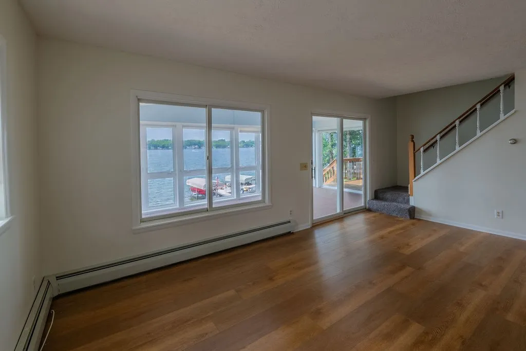 Main living room with lake views and tons of natural light from the 4 season enclosed porch