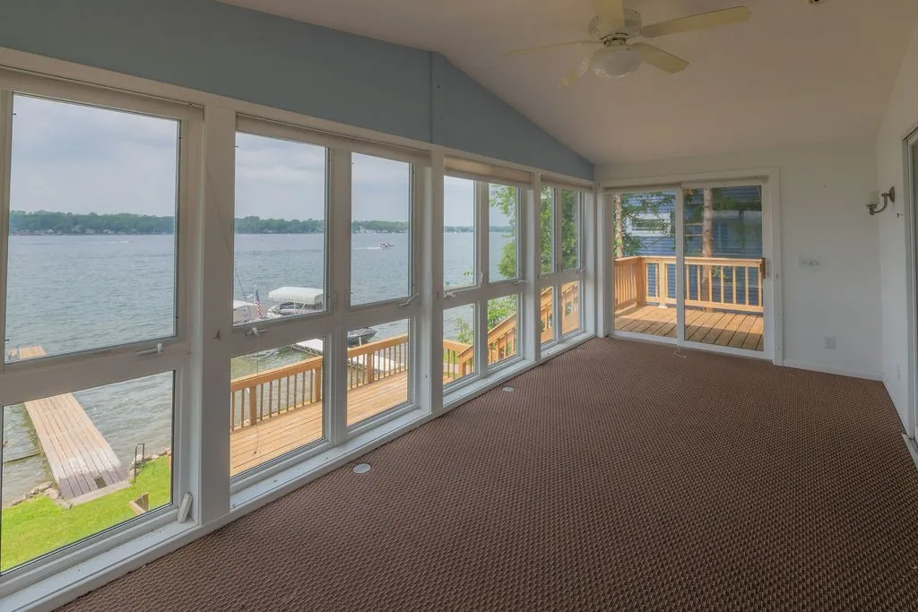 Enclosed 4 season room with sliders to the decks on either side
