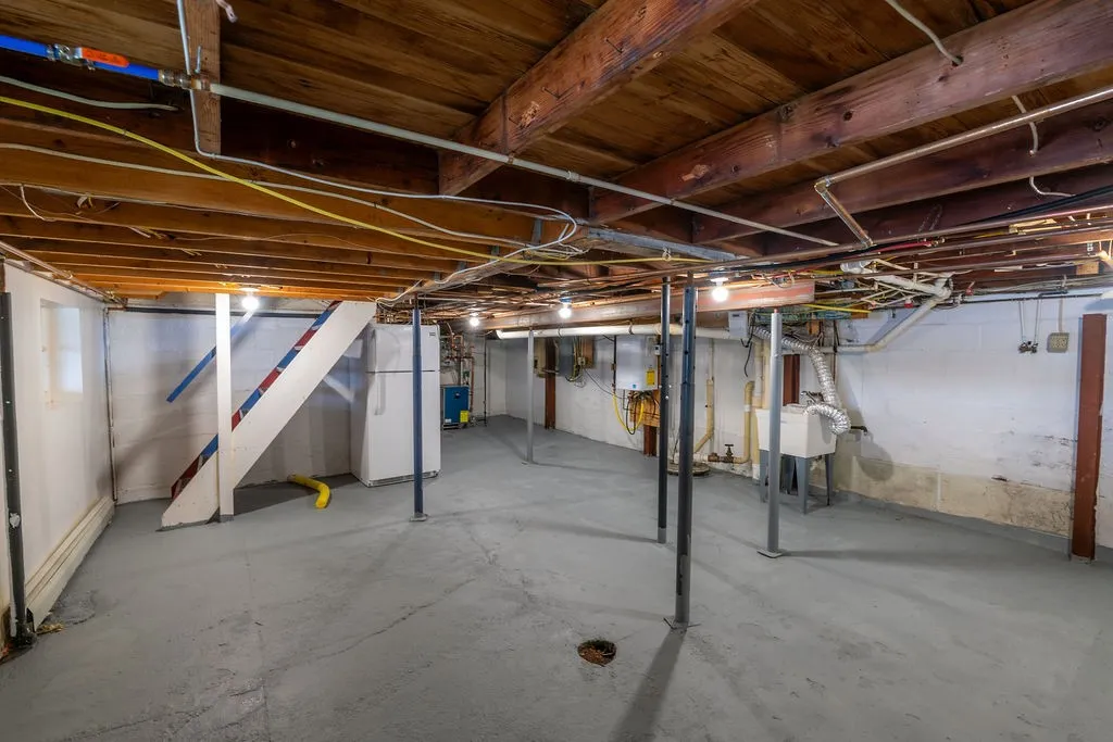 Walk out basement (door to left to exterior) has laundry hookups, tankless water heater, and brand new boiler ‘25.