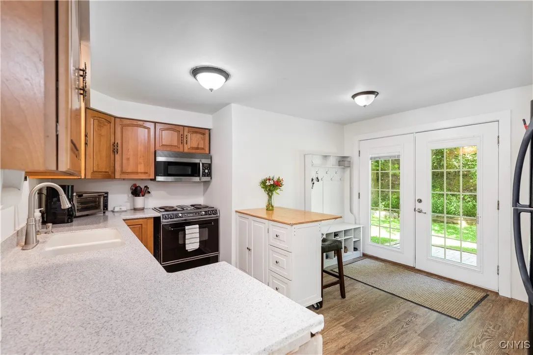 The kitchen is small but functional and bathed in natural light.