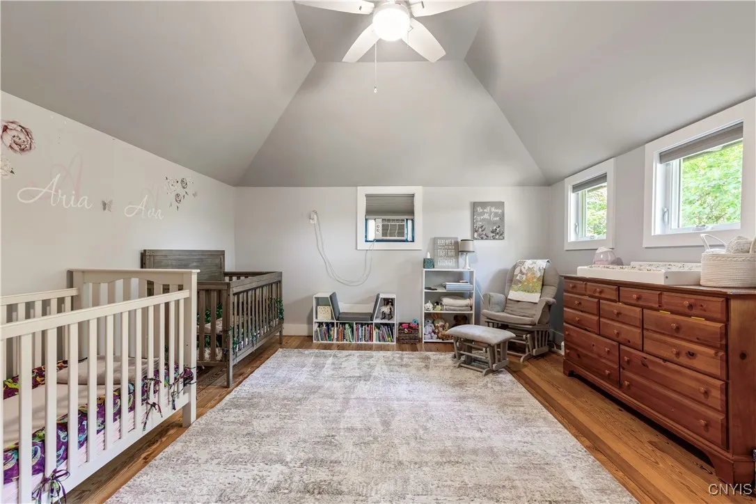 Upstairs this bedroom has been redone and is spacious. The tall ceilings and tree surroundings give it a calming feel.