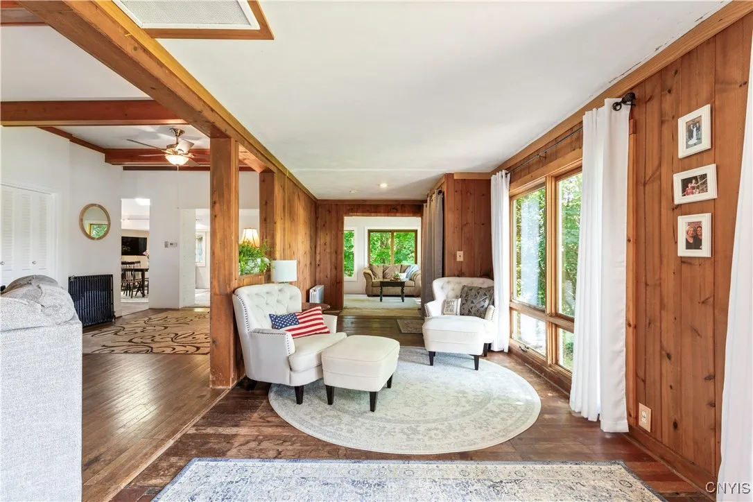 Looking from the fireplace, you see all the way through the front of the house into the sunroom. On the left is where the family room is; in the front left is an open space that could be used in a host of different ways. In the far left corner, you can see the dining table.