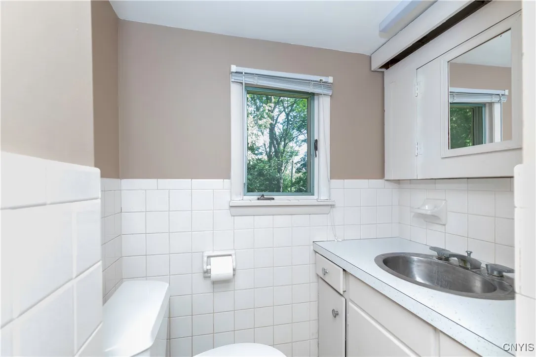 The half bath downstairs also includes a space for the laundry.