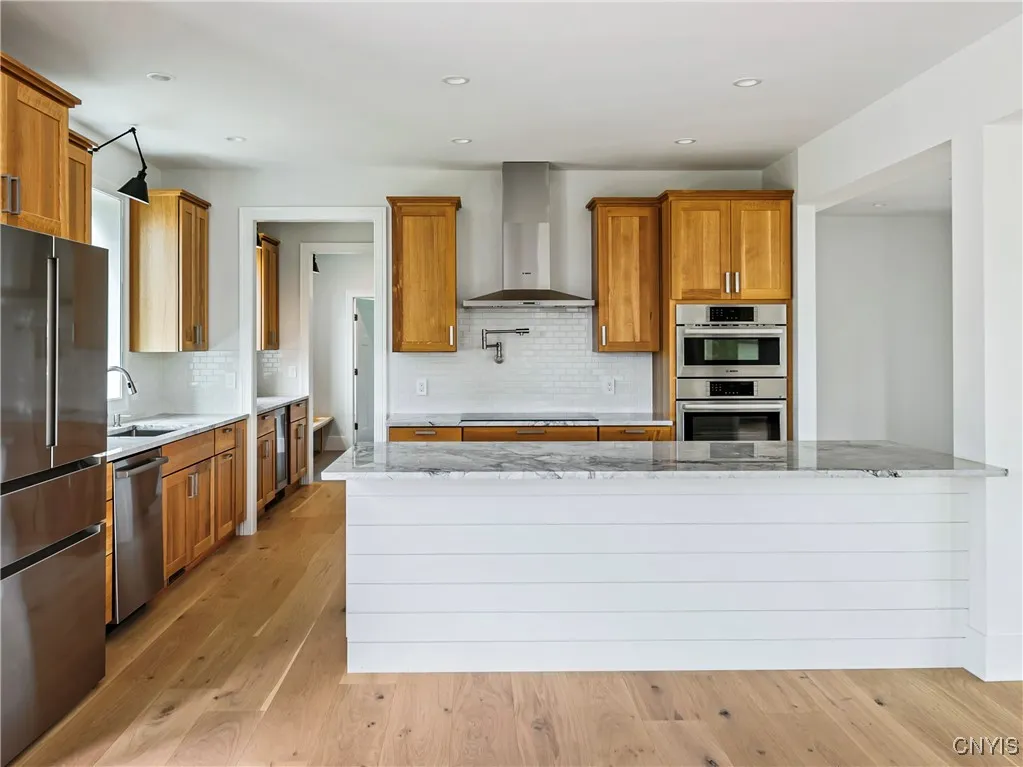 Kitchen with the pantry entry on the left which leads further to the mudroom and half-bath.