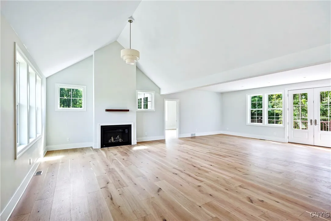A large dining room with a gas fireplace greets you upon entering.