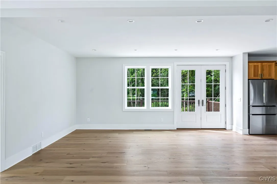 A large dining area adjoining the kitchen with the large double doors leading to the deck.