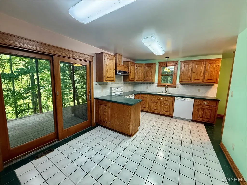 Slider by dining area of kitchen out to covered deck.