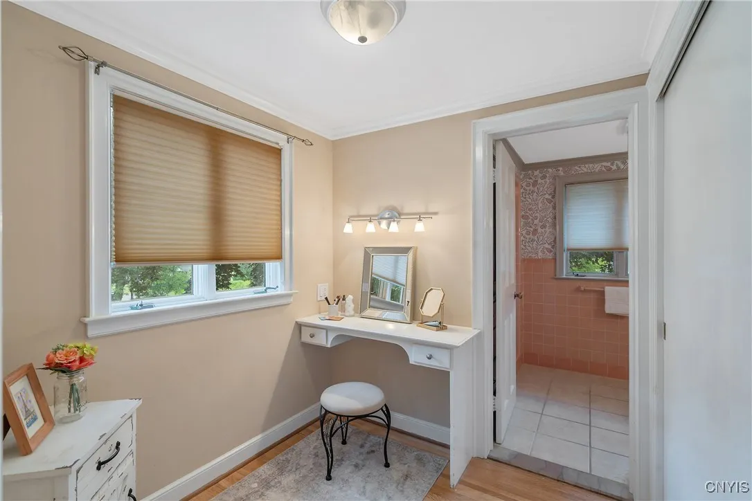 This swoon-worthy dressing area with another closet at right is just as inviting as it is useful! The built-in vanity counter here with light fixture above makes getting ready in the morning so enjoyable!