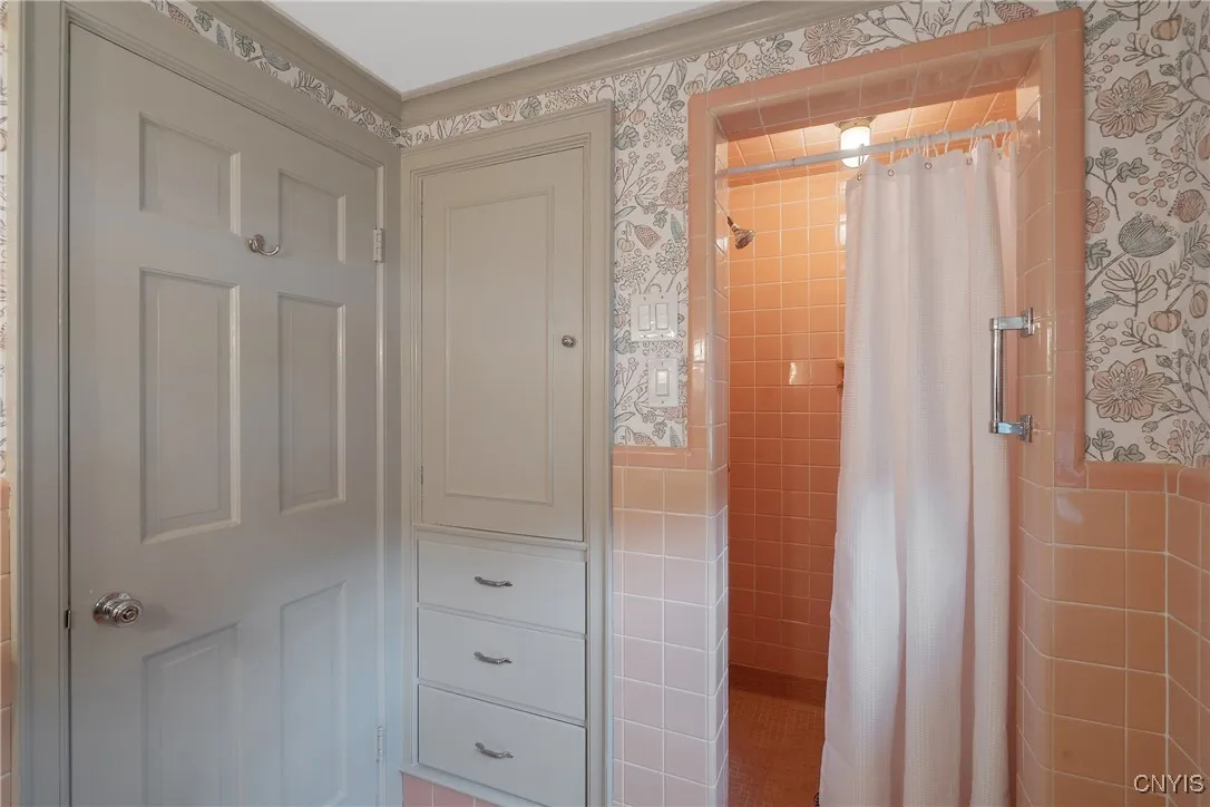 Built-in cabinets & drawers are thoughtfully located right next to the shower here.