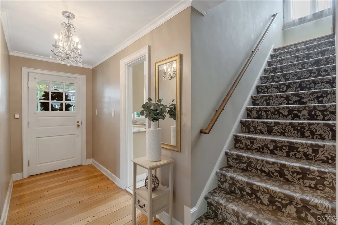 Stepping inside, the foyer has a grand feel with the elegant chandelier throwing light on this generous space. We see the stairs to the 2nd level here at right - but let's explore this main level first.