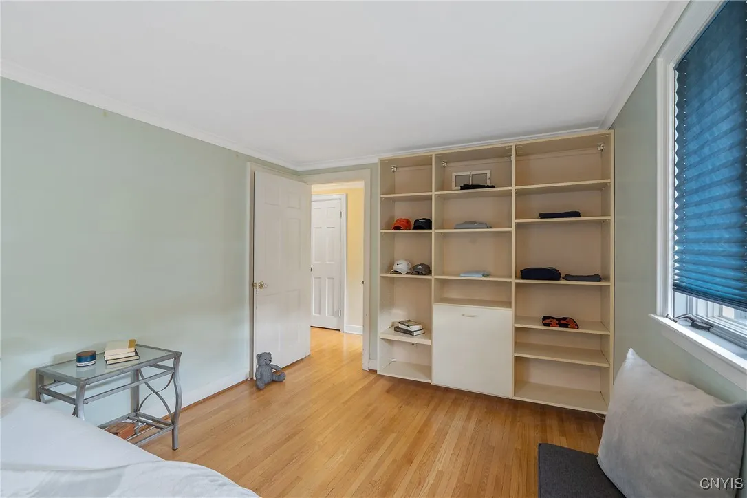 The open organizing system here on the wall includes a hamper feature at the center but there is a standard closet hidden behind the door, as well. And in the hall, a giant closet for linens or seasonal storage is seen.