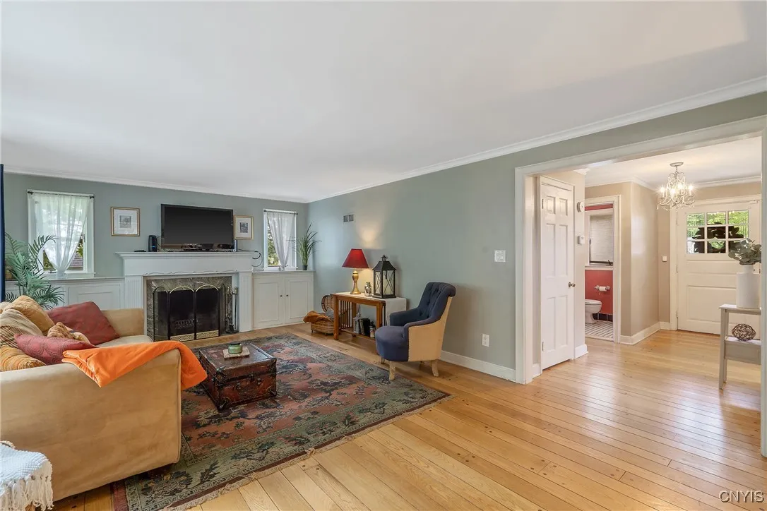 The fabulous pegged oak hardwood floors gleam as we pass the coat closet door ahead and enter the great room of the home.