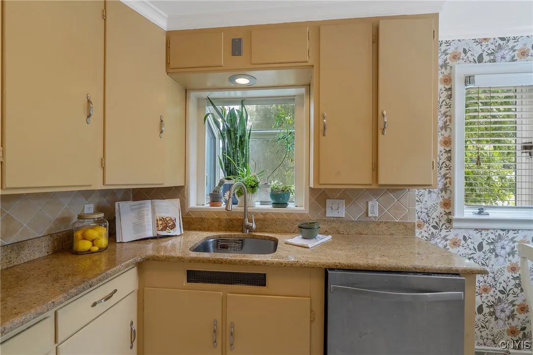 And the adorable garden window (above the sink with newer disposal) welcomes plants and herbs to nestle in!