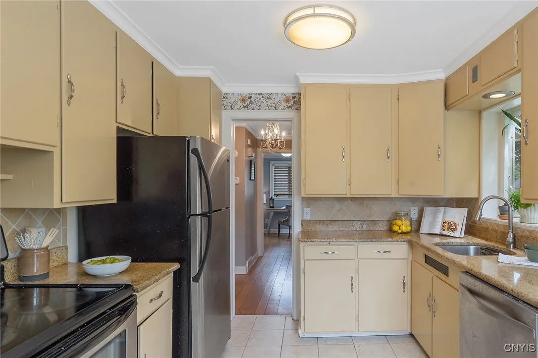 More cabinets on the opposite side of the refrigerator provide even more space for dry goods or house supplies. Now let's head across the foyer to the office/bedroom wing.