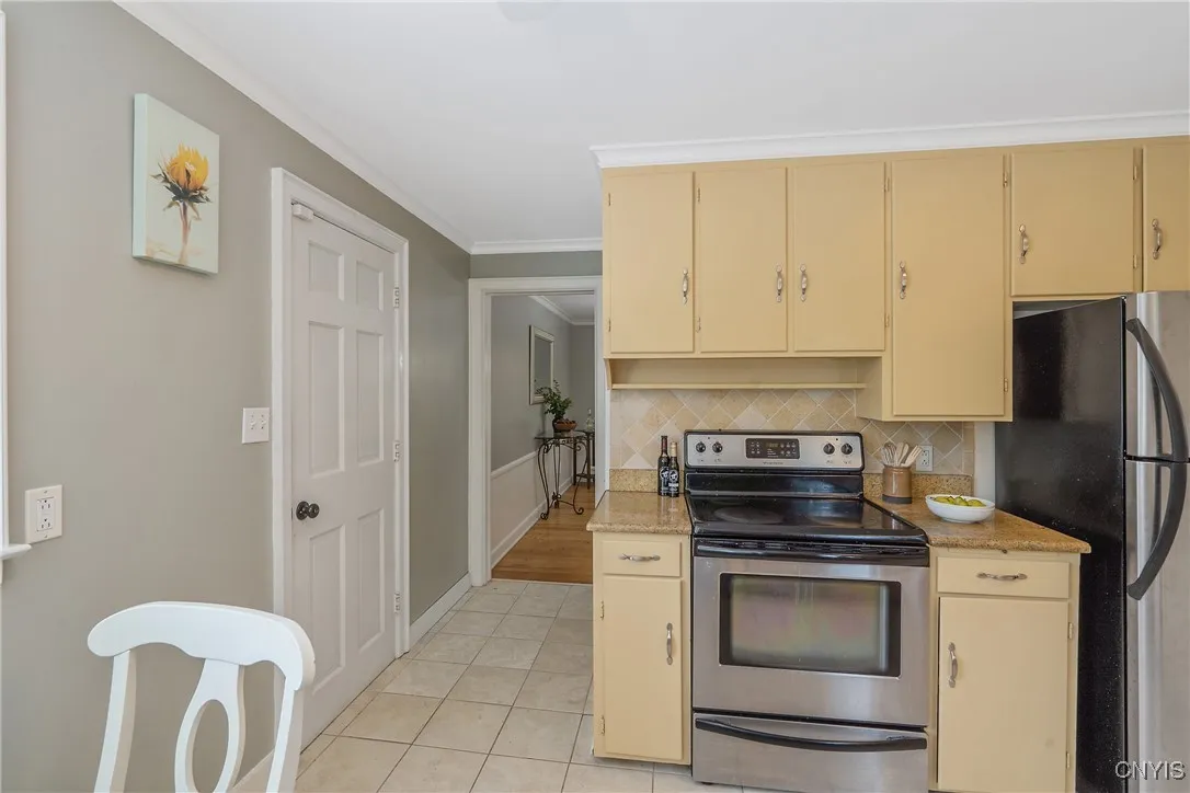 Ceramic floors greet you in this passage where the large 2-car garage is accessed through the door at left while a door not shown at right leads to the basement level we will tour later.