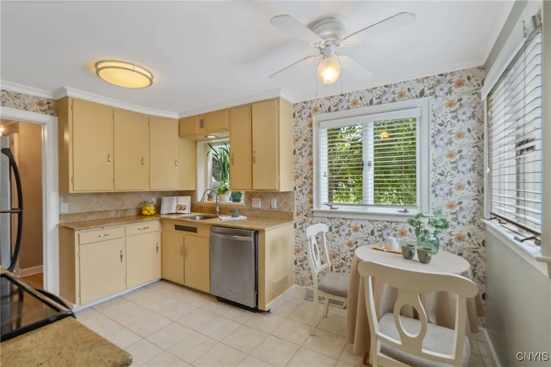 This cheery kitchen was refreshed just this last year with all new paint at the cabinets and drawers and new wallpaper.