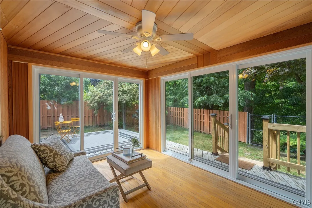 ...but also leads out to this PHENOMENAL 3-season room with an eye-catching wood patterned ceiling. WOW!