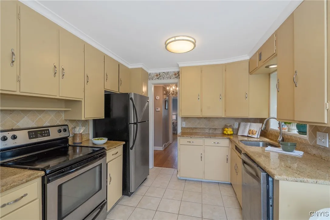 The granite counters sparkle and coordinate nicely with the alluring tile backsplash and stainless steel appliances.