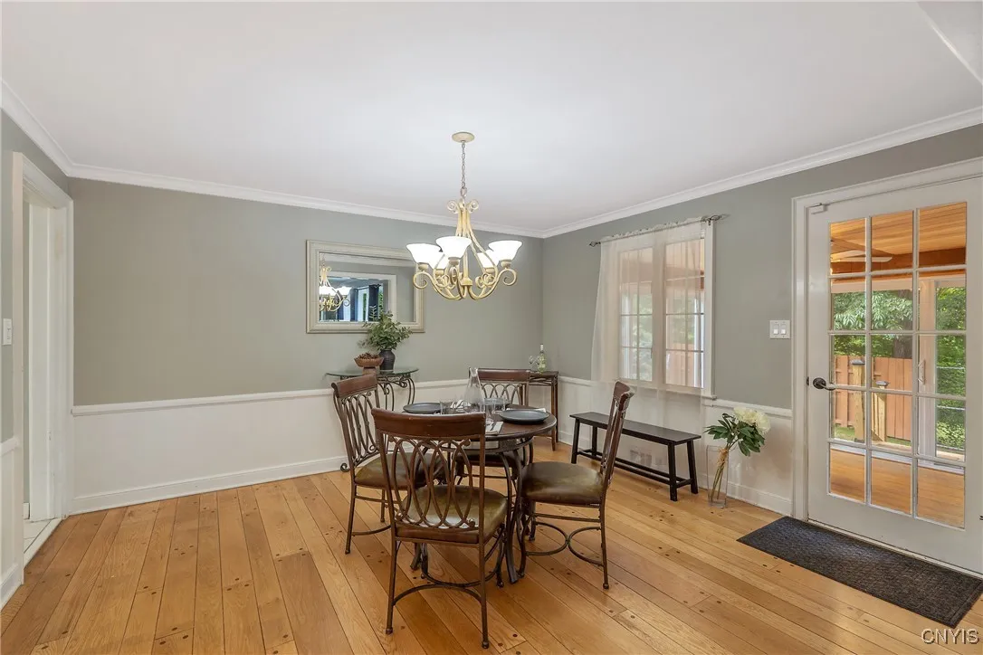The chair-rail detail adds a dramatic flair. And here at our right we see the atrium door that not only lets more natural light in...