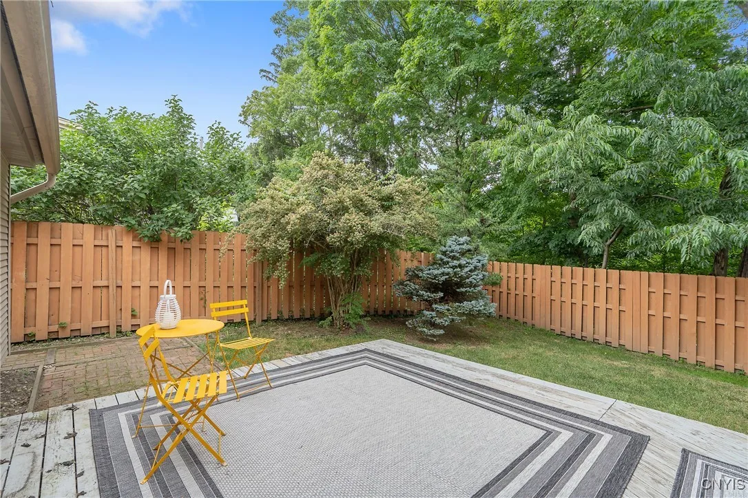 The privacy fence creates a secluded feel as the trees drape their limbs of gorgeous green above!