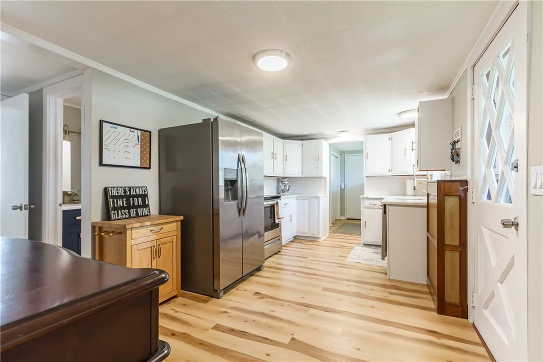 Charming \"White and Bright\" Kitchen with Quarts countertops and Stainless Steel appliances