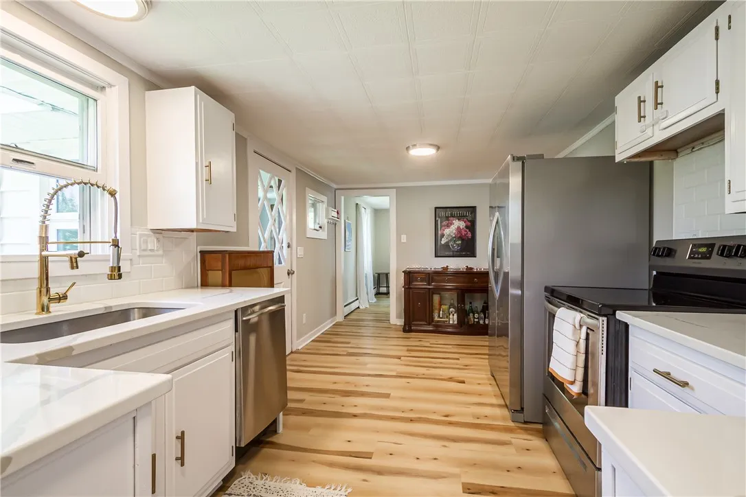 Charming \"White and Bright\" Kitchen with Quarts countertops and Stainless Steel appliances