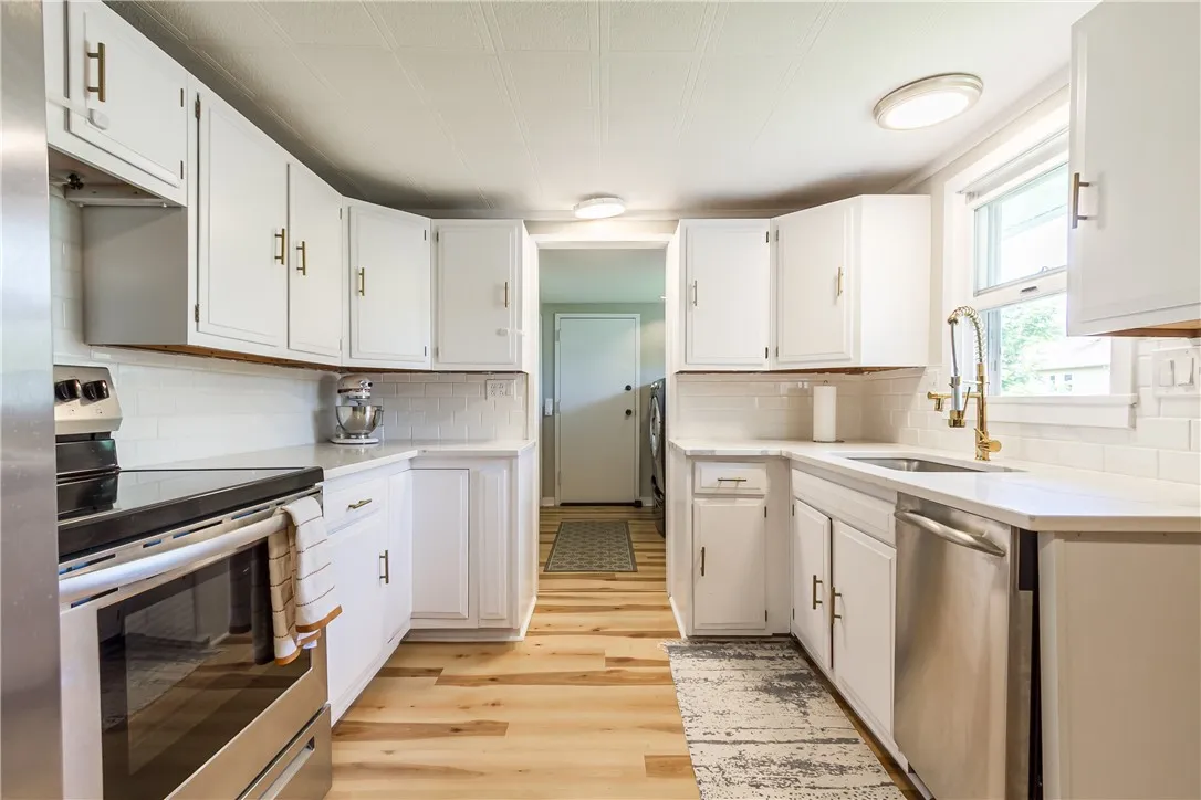 Charming \"White and Bright\" Kitchen with Quarts countertops and Stainless Steel appliances