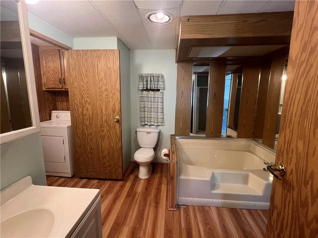Full bathroom with separate laundry room