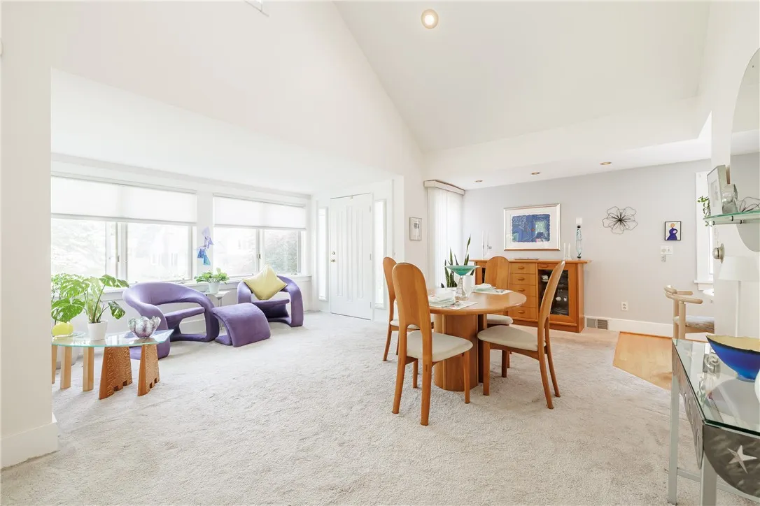 Dining room with soaring ceilings and lots of natural light.