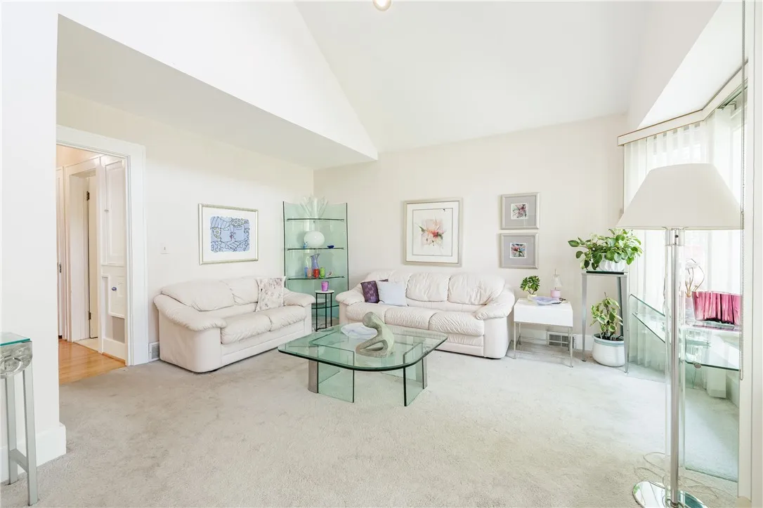 Living room: A very happy place to be. Recessed lighting with the cathedral ceilings. Hardwoods under carpet,