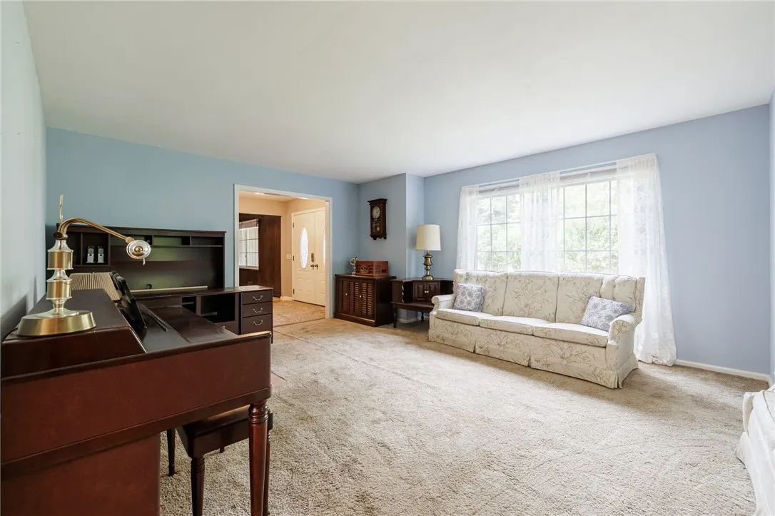 Living room off the front entry leads to the eat-in kitchen.