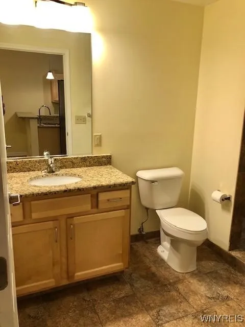 Large bathroom w/ granite counters.