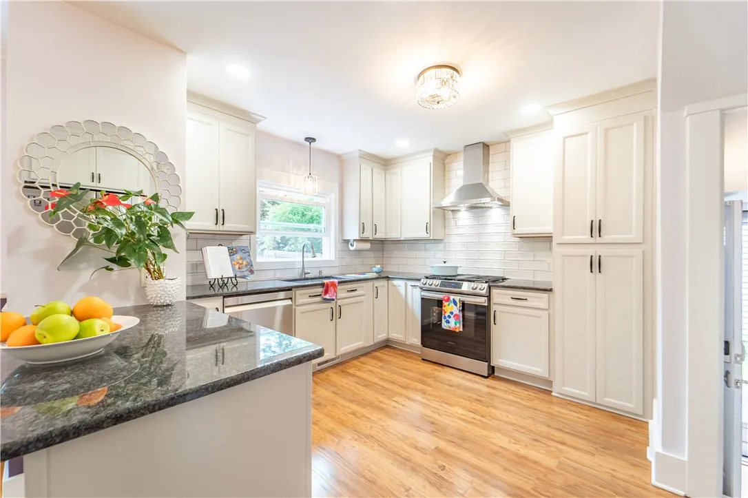 A delightful breakfast bar peninsula for casual meals, homework sessions, or entertaining separates the dining room and kitchen.