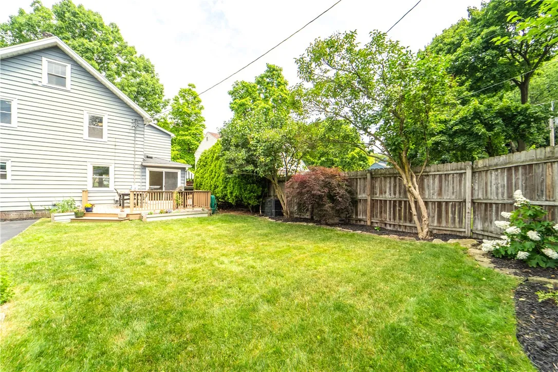 Raised beds overflow with herbs, while a graceful Japanese maple, blooming white hydrangeas, lilacs, lavender, and rhododendrons fill the yard with year-round color and fragrance — a true sanctuary for the senses.