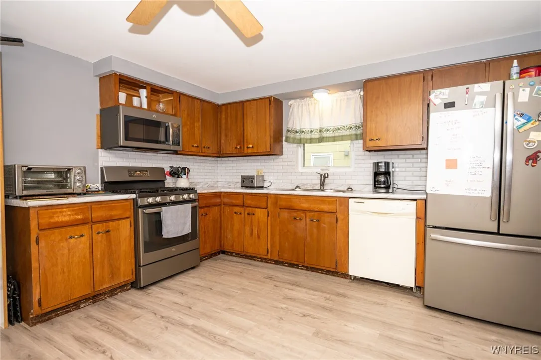 Lower:  Kitchen freshly painted, new countertops and backsplash