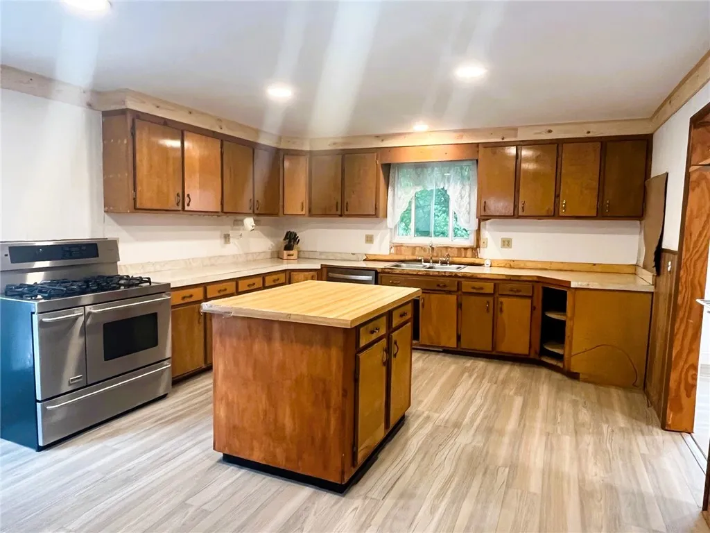 kitchen with new flooring, ceiling, and lighting