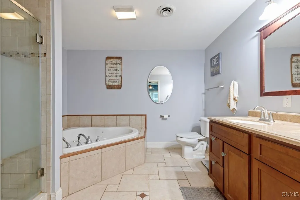 Primary Bath Suite w/ Custom Tile Walk-In Shower, Jetted Tub & Double Vanity.