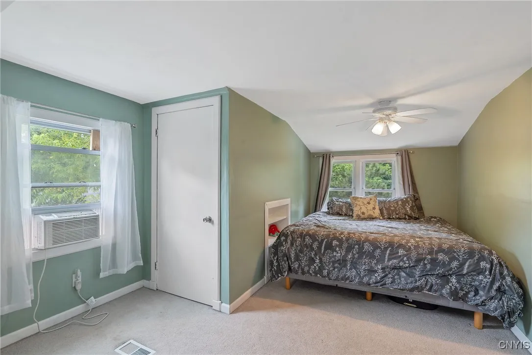 With two more bedrooms to see in the house, we step into #3.  The large space in the dormer can fit quite a big bed!  A closet is to our left, and don't miss the adorable built-in bookshelf next to the bed.