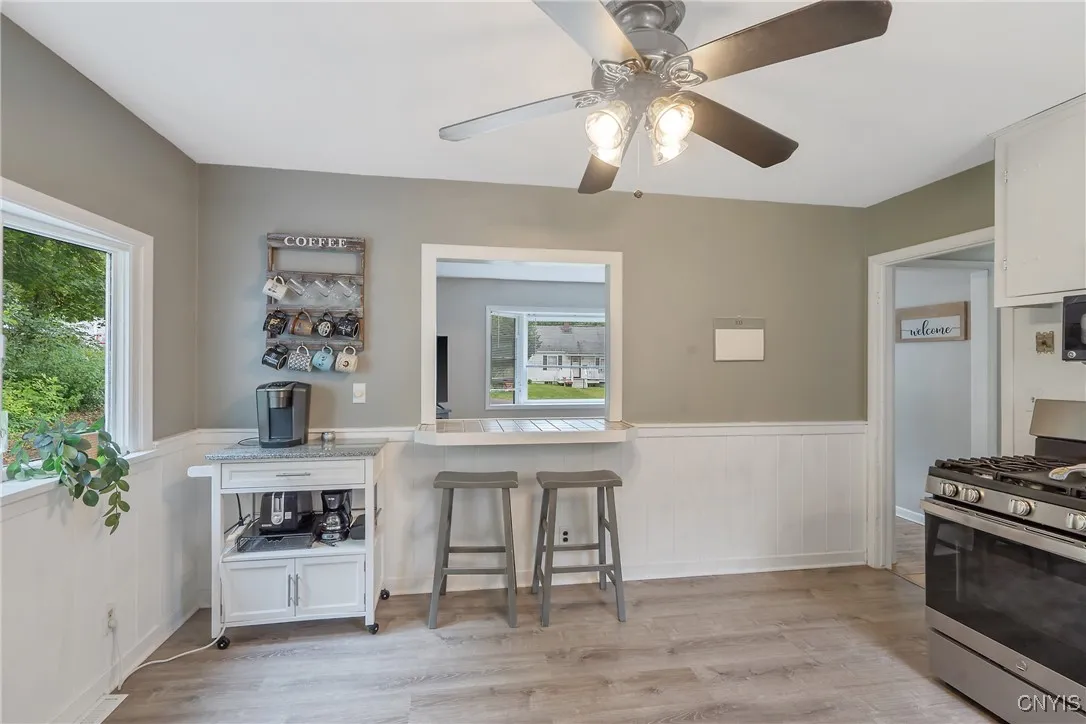 On this side of the pass-through window, we see it is actually a smartly designed breakfast bar for meals on the go (or to watch the big game in the family room...)  Plenty of space here to add an eat-in kitchen table as well.
