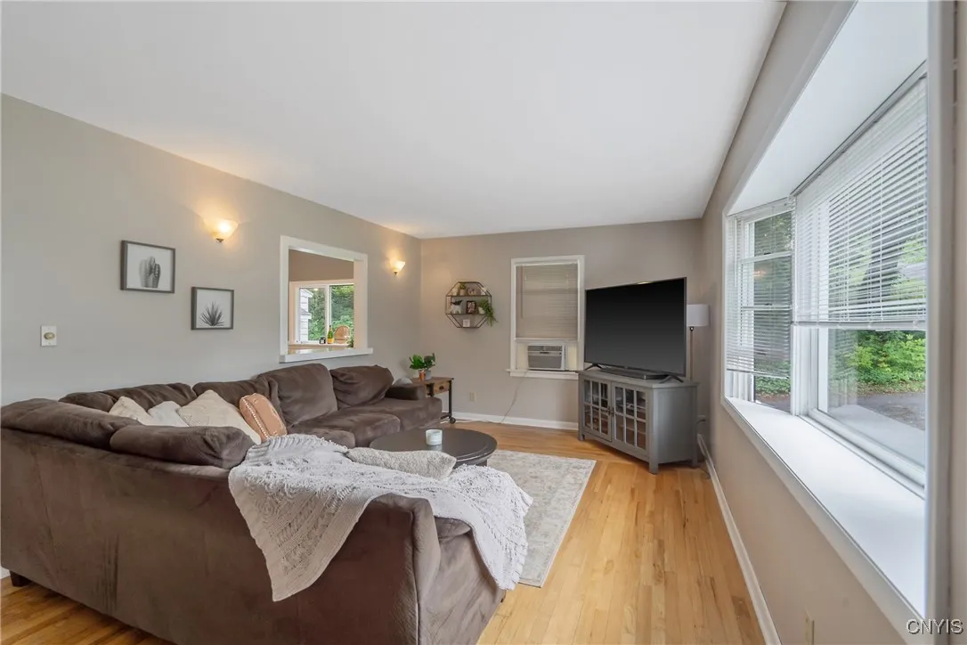 Attractive sconce lighting flanks the pass-through window into the eat-in kitchen.