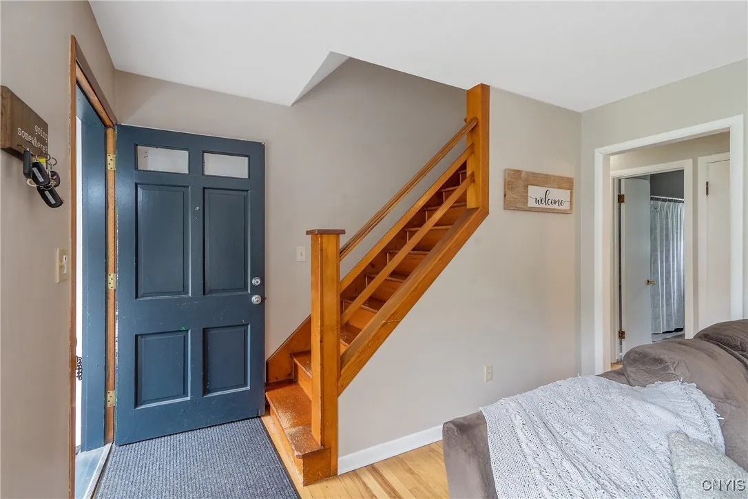 Now let's ascend to the bedroom level up the stairs with a great 50's style wood banister.