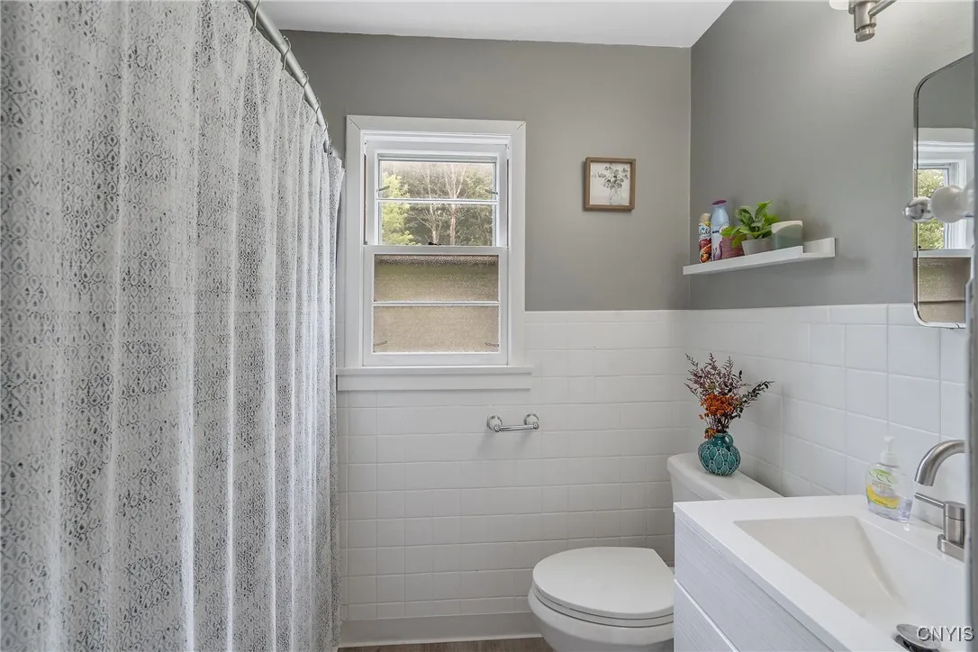 Just past the kitchen, we first find the full bathroom on this level.  Newly renovated with clean, classic tones and fixtures means this bathroom will stay in-style for years to come.