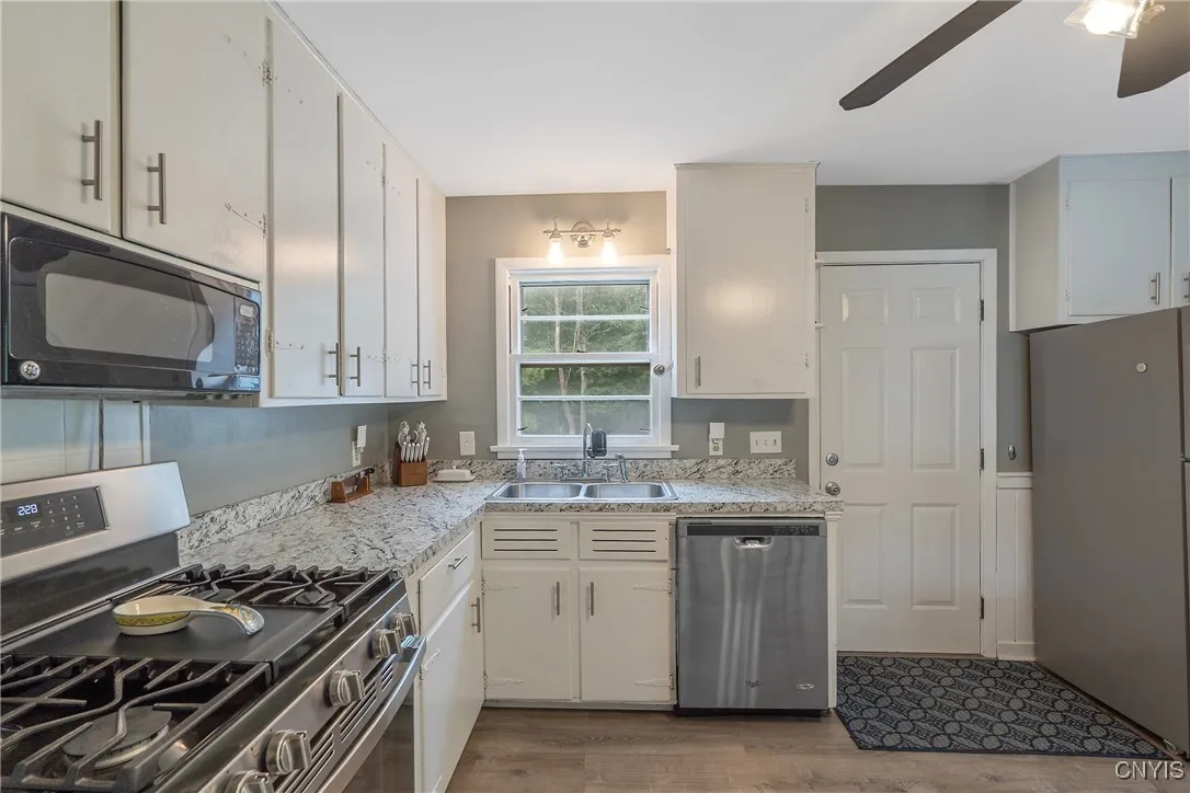 Lots of prep space on the new countertops, and tons of cabinet storage is sure to please the chef of the house.  And the door ahead steps out to the vast back yard, which we will explore later in the tour.