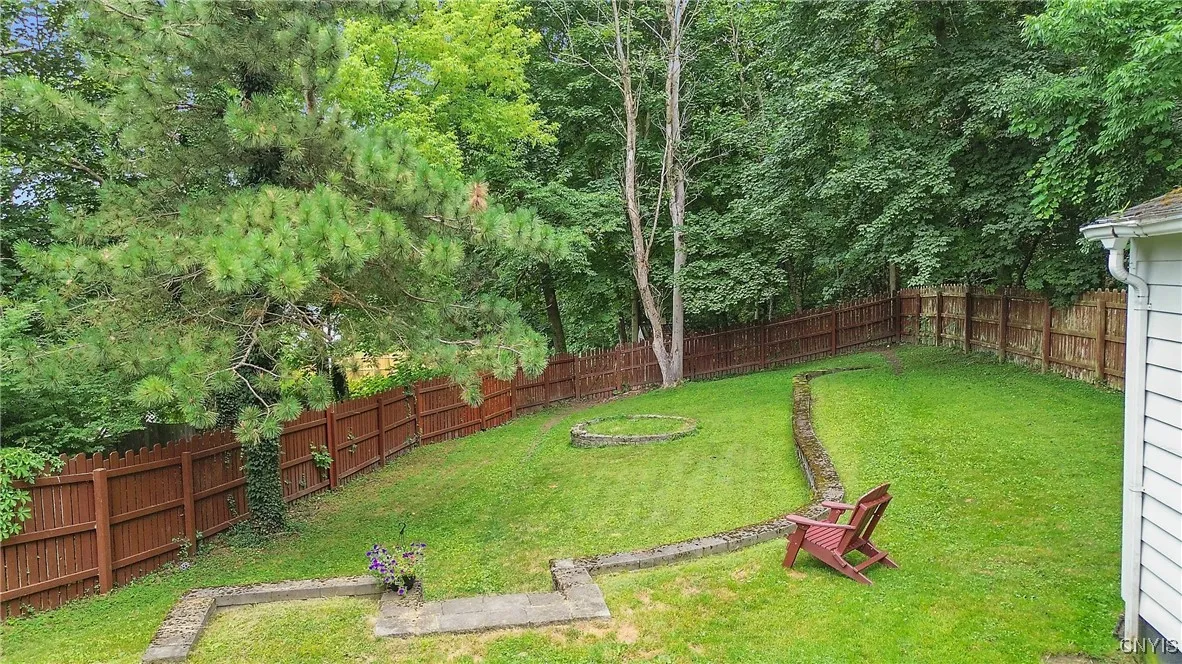 The view from the patio proves just how enormous the yard is. Surrounded by old-growth trees, the fully fenced yard is a true suburban oasis.