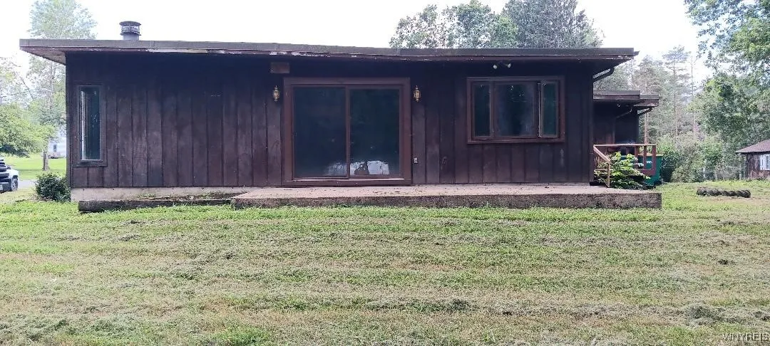 side 
large concrete patio 
sliders to family room