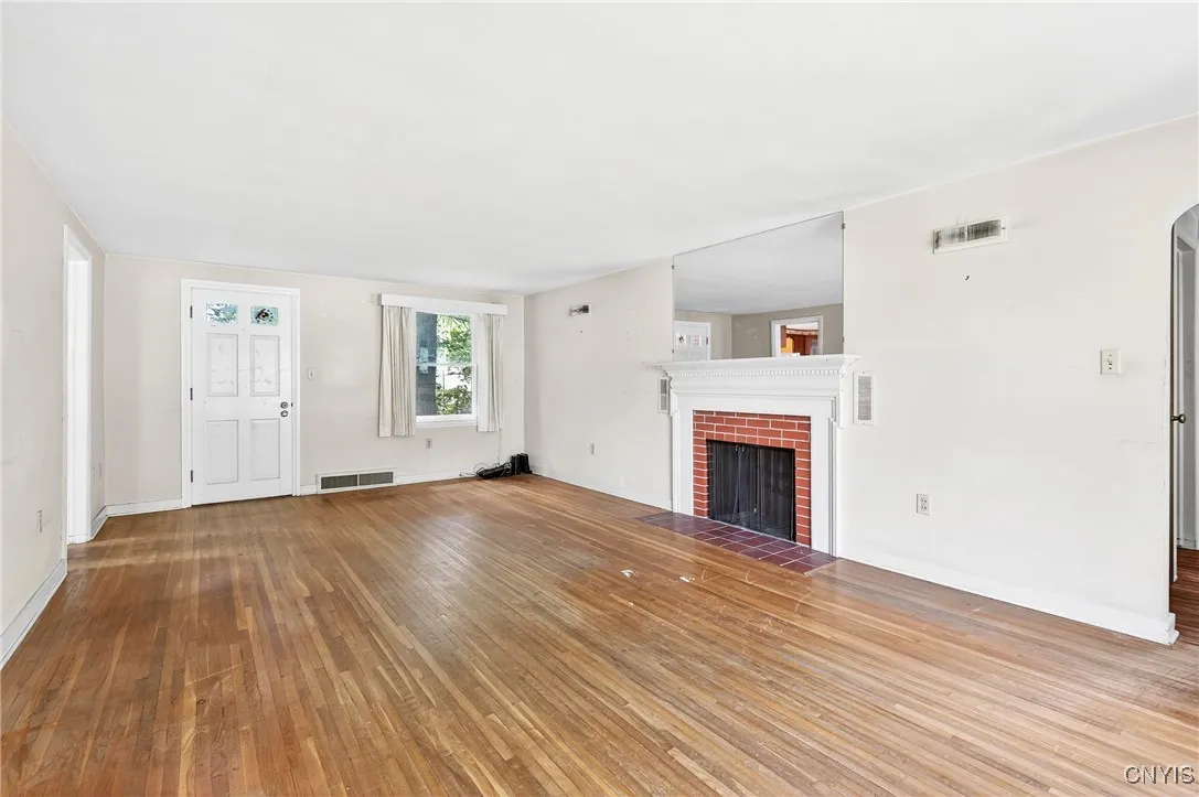 Classic brick fireplace and hardwoods.